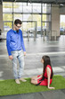 Business executives relaxing on grass mat in an office lobby