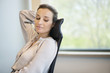 Businesswoman day dreaming in an office