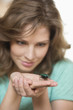 Woman looking at a beetle on her hands