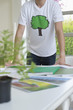 Plant and environmental awareness poster on a table in front of a man