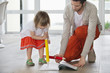 Man and daughter writing with big pencils