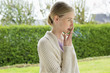 Woman smoking cigarette in park