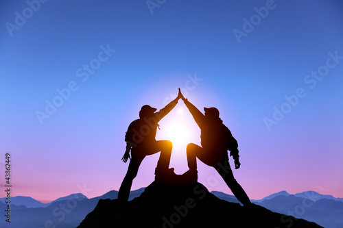 Photo: two man with success gesture on mountain two man with success gesture on mountain