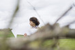 Boy holding an arrow sign in a field