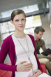 Portrait of a pregnant woman touching her abdomen