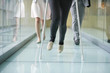 Low section view of three people walking in the corridor