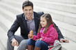 Man sitting with his daughter eating pain au chocolat