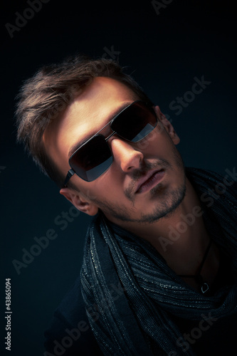 Photo: portrait of a handsome guy, wearing sunglasses, Low-key image portrait of a handsome guy, wearing sunglasses, Low-key image