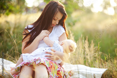 Photo: cute young mother with pretty infant son cute young mother with pretty infant son