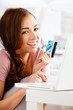 Photo: joyful young teenager shopping online with a credit card and lap joyful young teenager shopping online with a credit card and lap