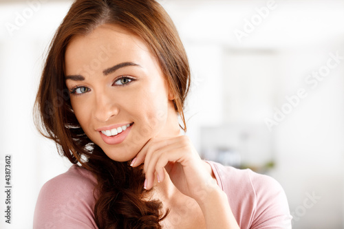 Photo: Close-up portrai of an attractive young woman smiling Close-up portrai of an attractive young woman smiling