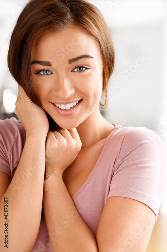 Photo: Close-up portrai of an attractive young woman smiling Close-up portrai of an attractive young woman smiling