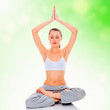 young girl practicing yoga, green blurred background
