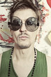 Portrait of young punk in round sunglasses