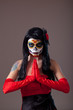 Praying woman with sugar skull make-up