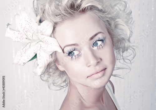 Photo: Beautiful young female portrait with original make up and flower Beautiful young female portrait with original make up and flower