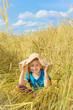 Foto: Funny girl sits among the tall rye. Funny girl sits among the tall rye.