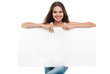 Beautiful woman holding a blank billboard