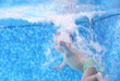 Photo: Little boy after diving into a swimming pool, hand in focus Little boy after diving into a swimming pool, hand in focus