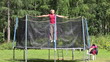 Woman jumping on a trampoline, the background of the forest