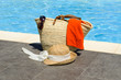 Bag with towel, sunglasses and a hat