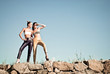 Two fashion girls outdoors against blue sky background
