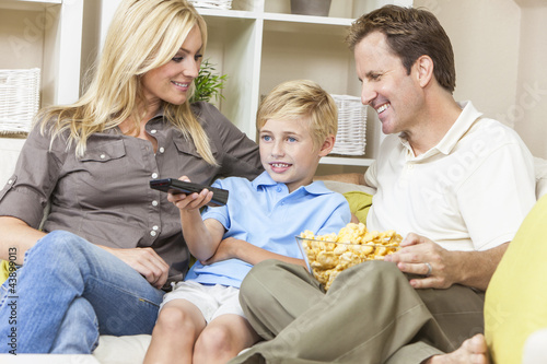 Foto: Happy Family Sitting on Sofa Watching Television Happy Family Sitting on Sofa Watching Television