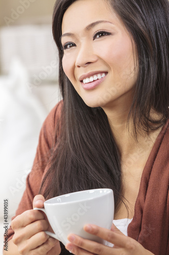 Photo: Beautiful Chinese Oriental Asian Woman Drinking Tea or Coffee Beautiful Chinese Oriental Asian Woman Drinking Tea or Coffee