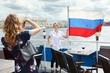 Photo: Woman photographing with Russian flag on ship deck Woman photographing with Russian flag on ship deck