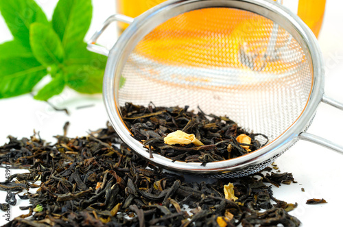Photo: Dried Tea Leaves with Sieve and Tea Cup Dried Tea Leaves with Sieve and Tea Cup