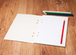 pencils and notebook on wooden table