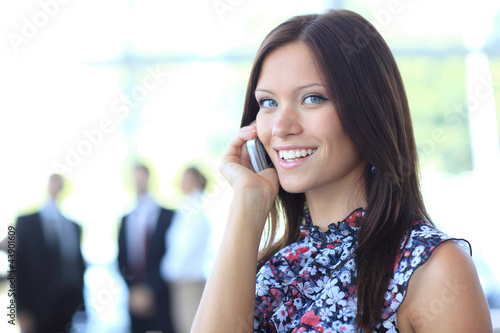 Photo: Beautiful business woman talking on cell phone Beautiful business woman talking on cell phone