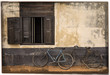 2 old bicycles and a window