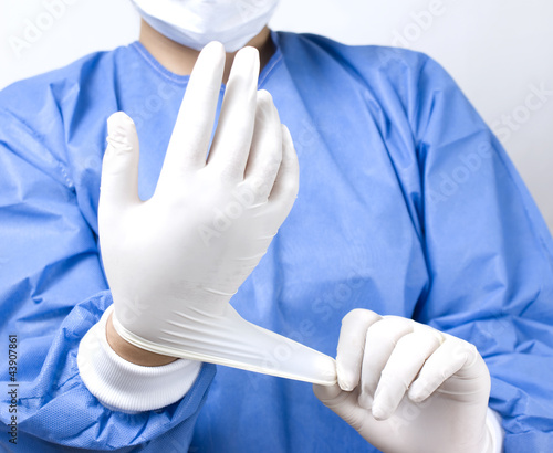 Photo: doctor putting gloves doctor putting gloves