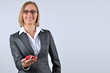 Businesswoman holding and showing a toy car on her hand
