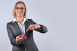 Businesswoman holding and showing a toy car on her hand