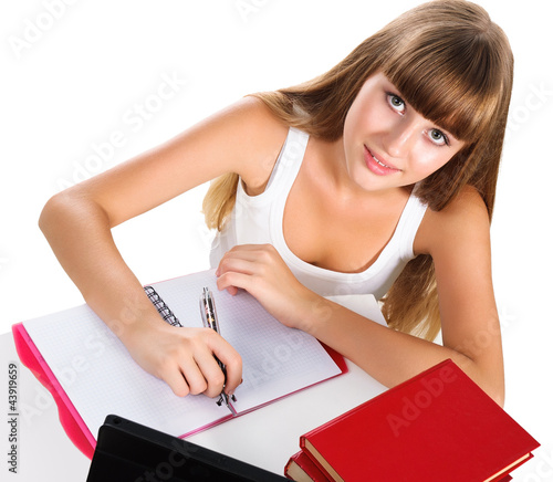 Foto: cute teen girl homeschooling with books and tablet isolated over cute teen girl homeschooling with books and tablet isolated over