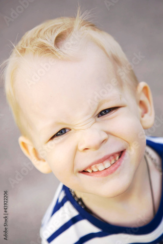 Photo: smiling little boy with blond hair and blue eyes close up. smiling little boy with blond hair and blue eyes close up.
