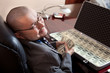 Serious businessman with the suitcase full of dollars