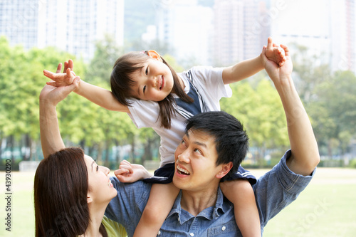 Photo: Chinese Family Giving Daughter Ride On Shoulders In Park Chinese Family Giving Daughter Ride On Shoulders In Park