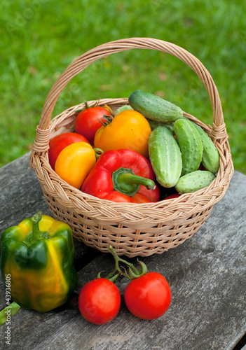 Photo: vegetables in a basket on wooden table vegetables in a basket on wooden table