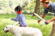 Father Playing Exciting Adventure Game With Son And Dog