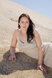 Beautiful brunette  layed down on the sand