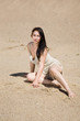 Young woman sitting alone in desert
