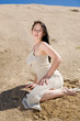 Beautiful brunette sitting alone in desert