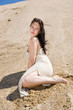 Beautiful brunette sitting alone in desert