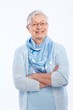 Smiling elderly lady standing arms crossed