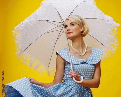Photo: Woman in blue dress with a parasol Woman in blue dress with a parasol