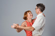 Happy elegant senior couple is dancing.