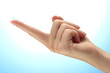 contact lens on finger on blue background
